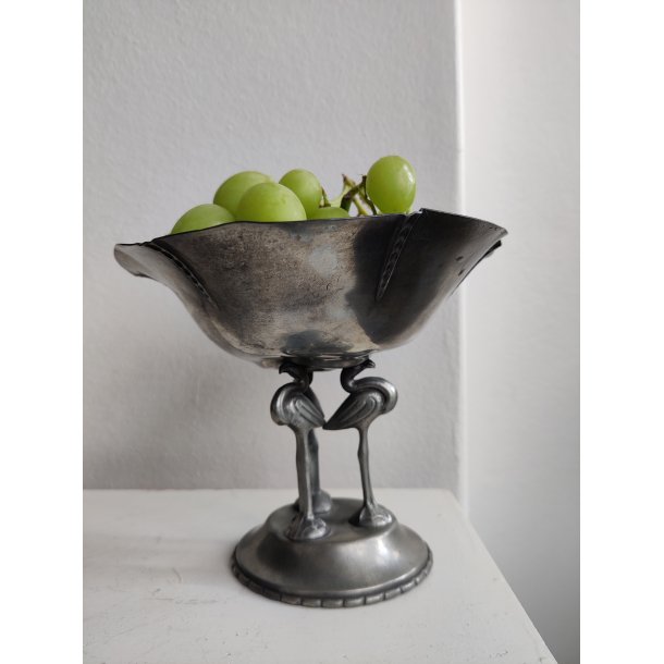 Tinopsats med tre flamingoer